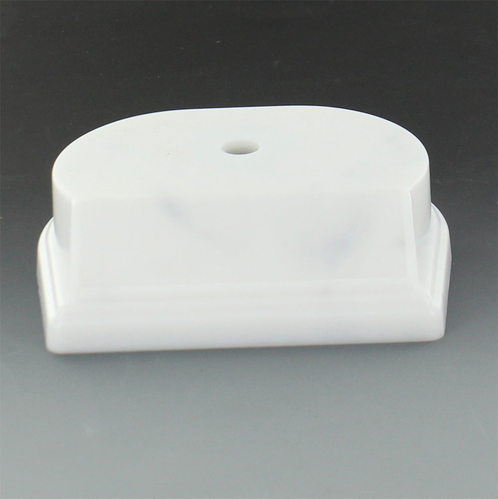 SYNTHETIC MARBLEIZED WHITE TROPHY BASE 4 1/4 INCH X 3 1/2 INCH 1 1/8 INCH. BEVELED EDGE SLANTED FRONT HOLDS 3 INCH X 7/8 INCH PLATE. CENTER HOLE COUNTER SANK.