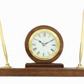 WALNUT FINISH PEN SET WITH QUARTZ BRASS CLOCK WITH BLACK ENGRAVING PLATE. 11 INCH LENGTH X 3 INCH WIDTH X 5 1/2 HEIGHT.